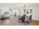 Open-concept living area with wood floors, neutral decor, and ample natural light at 4117 W Camino Acequia Ave, Phoenix, AZ 85051