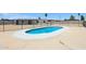 A refreshing blue pool surrounded by a patio and black fence, perfect for outdoor relaxation and entertainment at 4117 W Camino Acequia Ave, Phoenix, AZ 85051