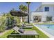 Backyard with a pool, lounge chairs, and a modern home exterior in a lush setting at 4120 N 44Th Pl, Phoenix, AZ 85018