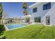 Expansive backyard showcasing a modern pool, manicured lawn, and sleek home exterior at 4120 N 44Th Pl, Phoenix, AZ 85018
