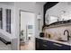 Stylish bar area with sleek cabinetry, marble countertop, and view to a modern bath at 4120 N 44Th Pl, Phoenix, AZ 85018