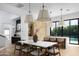 Spacious kitchen-dining area with an island, wood cabinets, pendant lights, and easy pool access at 4120 N 44Th Pl, Phoenix, AZ 85018
