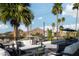 Entertainer's rooftop patio with mountain views, a lounge area, an outdoor dining space, and lush palm trees at 4120 N 44Th Pl, Phoenix, AZ 85018