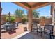 Inviting covered back patio with outdoor seating, brick pavers and a well, perfect for relaxation at 4553 W Kirkland Ave, San Tan Valley, AZ 85144