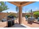 Comfortable covered back patio with a grill, and brick pavers, ideal for outdoor cooking and entertaining at 4553 W Kirkland Ave, San Tan Valley, AZ 85144