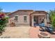 Spacious backyard with drought tolerant landscaping, brick paved patio, firepit, and covered patio at 4553 W Kirkland Ave, San Tan Valley, AZ 85144