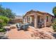 Wide view of backyard with brick paved patio, furniture, fire pit and drought tolerant landscaping at 4553 W Kirkland Ave, San Tan Valley, AZ 85144