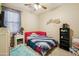 Vibrant bedroom with unique decor and a large window, offering a comfortable and inviting space, and fan at 4553 W Kirkland Ave, San Tan Valley, AZ 85144