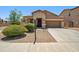 A tan single-story home with a well-kept yard and landscaping, featuring a two-car garage at 4553 W Kirkland Ave, San Tan Valley, AZ 85144