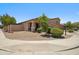 A tan single story home boasts manicured landscaping with decorative rock in the front yard at 4553 W Kirkland Ave, San Tan Valley, AZ 85144
