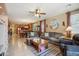 Spacious living room seamlessly flows into the kitchen, offering an open-concept living space, with tiled flooring and fan at 4553 W Kirkland Ave, San Tan Valley, AZ 85144