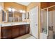 Bathroom features a double sink vanity, ample counter space, and a separate shower for added convenience, with tiled floors at 4553 W Kirkland Ave, San Tan Valley, AZ 85144
