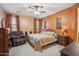 Cozy bedroom features carpeted floors, soft lighting, and matching furniture, creating a relaxing retreat, with ceiling fan at 4553 W Kirkland Ave, San Tan Valley, AZ 85144