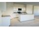 Bright kitchen showcasing an island, granite countertops, stainless steel appliances, and modern white cabinetry at 5701 E Iris Dr, Florence, AZ 85132