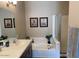 Bathroom with a soaking tub, double sinks, and a framed mirror, perfect for relaxation at 6605 N 93Rd Ave # 1071, Glendale, AZ 85305