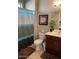 Cozy bathroom featuring a shower with curtain, toilet, vanity, and decorative art at 6605 N 93Rd Ave # 1071, Glendale, AZ 85305