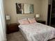 Well-lit bedroom featuring contemporary artwork, bedside tables, and unique linens at 6605 N 93Rd Ave # 1071, Glendale, AZ 85305