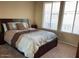 Cozy bedroom with neutral carpet, a comfortable bed, and ample natural light from the window at 6605 N 93Rd Ave # 1071, Glendale, AZ 85305