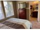 Bright bedroom with large windows, a TV on a dresser, and an ensuite bathroom at 6605 N 93Rd Ave # 1071, Glendale, AZ 85305