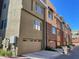 Multi-story townhome complex with garages and a contemporary design, enhancing curb appeal with a variety of neutral color accents at 6605 N 93Rd Ave # 1071, Glendale, AZ 85305