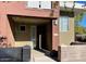 Townhouse featuring a covered front porch and stone accents, enhancing curb appeal at 6605 N 93Rd Ave # 1071, Glendale, AZ 85305