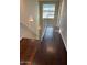 Well-lit hallway featuring wood floors, a modern railing, and contemporary lighting at 6605 N 93Rd Ave # 1071, Glendale, AZ 85305