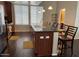 Open kitchen featuring a breakfast bar with seating, stainless steel appliances, and dark wood cabinetry at 6605 N 93Rd Ave # 1071, Glendale, AZ 85305