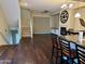 Open floor plan combining the kitchen, dining, and living area with hardwood floors and a fireplace at 6605 N 93Rd Ave # 1071, Glendale, AZ 85305