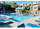 Community pool surrounded by lounge chairs and lush landscaping, offering a refreshing oasis for relaxation and social gatherings at 6605 N 93Rd Ave # 1071, Glendale, AZ 85305