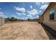 Expansive backyard with potential for landscaping and outdoor living, complemented by a clear blue sky at 6713 S 76Th Dr, Laveen, AZ 85339