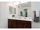 Double sink vanity featuring framed mirrors, great lighting, and attractive fixtures at 6713 S 76Th Dr, Laveen, AZ 85339