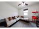 A comfortable bonus room with a sectional sofa, popcorn machine, and ceiling fan at 6713 S 76Th Dr, Laveen, AZ 85339