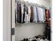Well-organized walk-in closet with ample hanging space for shirts, pants, and shoes at 6713 S 76Th Dr, Laveen, AZ 85339