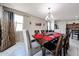 Dining room with seating for eight, featuring tile floors, and a view of the backyard at 6713 S 76Th Dr, Laveen, AZ 85339