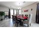 Bright dining room with seating for eight, neutral walls, tile floors, and backyard access at 6713 S 76Th Dr, Laveen, AZ 85339
