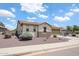 A single story home with tan stucco, a stone facade, desert landscaping, and a two-car garage at 6713 S 76Th Dr, Laveen, AZ 85339