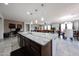 Bright kitchen showcasing a central island with granite countertop, stainless appliances, and an open floorplan at 6713 S 76Th Dr, Laveen, AZ 85339