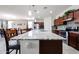 A spacious kitchen featuring a large island with granite countertops and seating, next to the dining area at 6713 S 76Th Dr, Laveen, AZ 85339