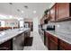 Bright kitchen showcasing a central island with granite countertop, stainless appliances, and tile backsplash at 6713 S 76Th Dr, Laveen, AZ 85339