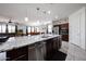 A spacious kitchen featuring a large island with granite countertops, and stainless steel appliances at 6713 S 76Th Dr, Laveen, AZ 85339