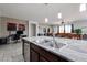 Open-concept kitchen featuring a large island with granite countertops and stainless steel sink at 6713 S 76Th Dr, Laveen, AZ 85339