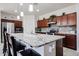 A spacious kitchen featuring a large island with granite countertops and stainless steel appliances at 6713 S 76Th Dr, Laveen, AZ 85339