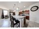 A spacious kitchen featuring a large island with granite countertops, dark wood cabinets and tile flooring at 6713 S 76Th Dr, Laveen, AZ 85339
