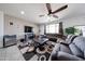 Comfortable living room featuring a large sectional couch, ceiling fan, and tile flooring at 6713 S 76Th Dr, Laveen, AZ 85339
