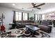 Spacious living room with a large sectional couch, ceiling fan, and an accent rug at 6713 S 76Th Dr, Laveen, AZ 85339