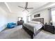 Spacious main bedroom featuring a ceiling fan, sitting area, and stylish, modern furnishings at 6713 S 76Th Dr, Laveen, AZ 85339