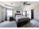 Comfortable main bedroom featuring a ceiling fan, carpet flooring, and natural lighting at 6713 S 76Th Dr, Laveen, AZ 85339