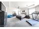 Bright main bedroom with a bed, treadmill, sitting area, and large dresser at 6713 S 76Th Dr, Laveen, AZ 85339