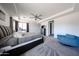A view of the carpeted primary bedroom with a sitting area and plenty of natural light at 6713 S 76Th Dr, Laveen, AZ 85339