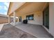 Covered patio area, perfect for outdoor dining and entertaining, complete with concrete flooring at 6713 S 76Th Dr, Laveen, AZ 85339